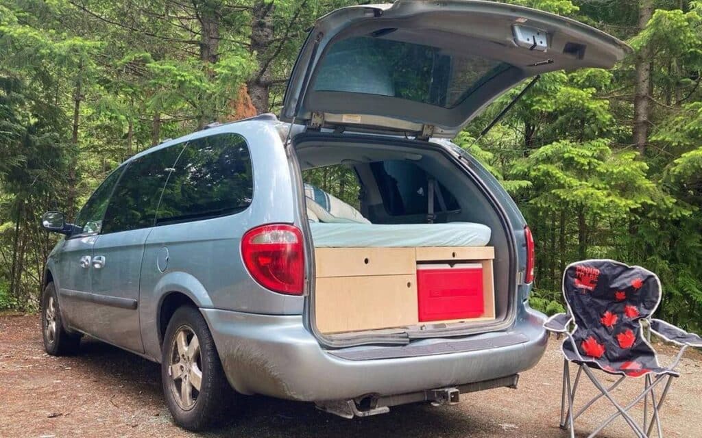 @vita_vans Rear view of Grand caravan camper parked in the forest