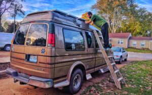 vanlifer mounting the best solar panels for van conversion power systems on his campervan