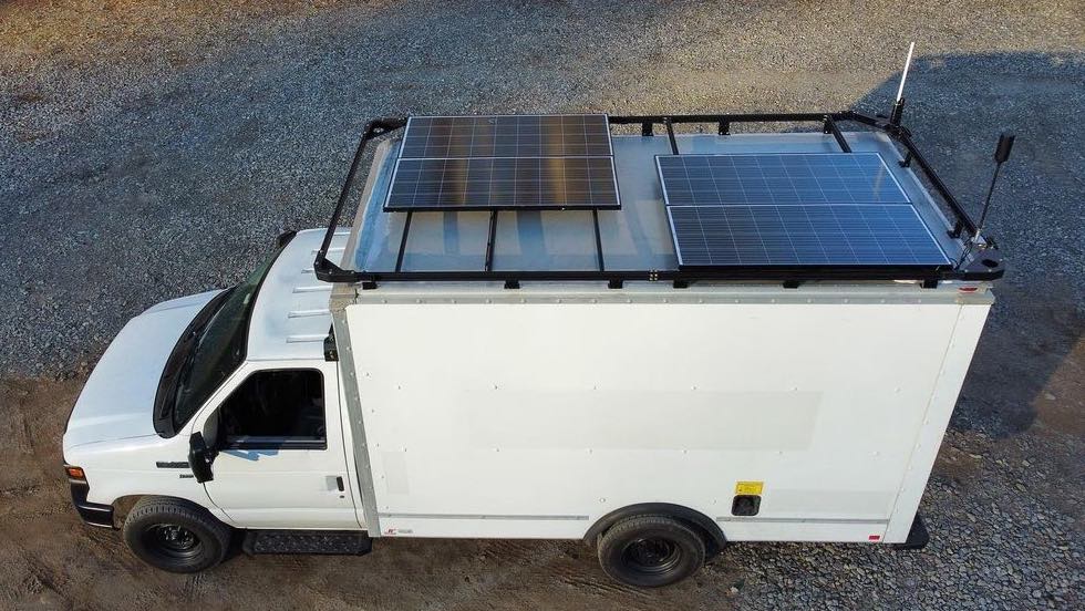 campervan solar panels mounted to the roof rack of a box truck