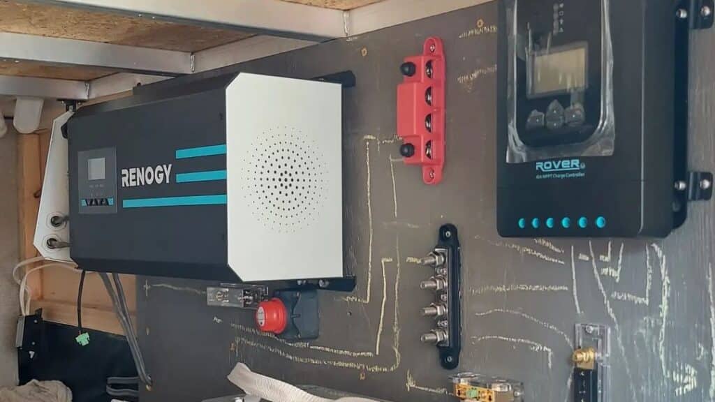 Renogy inverter and charge controller mounted on wall with wiring drawn out