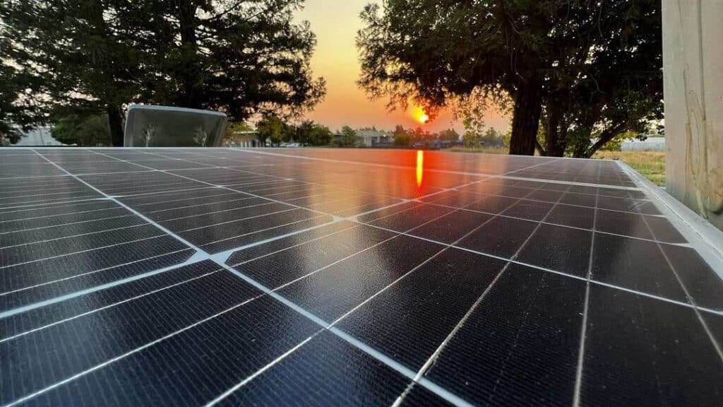 close up of monocrystalline solar panels on rv roof with sunset in the background
