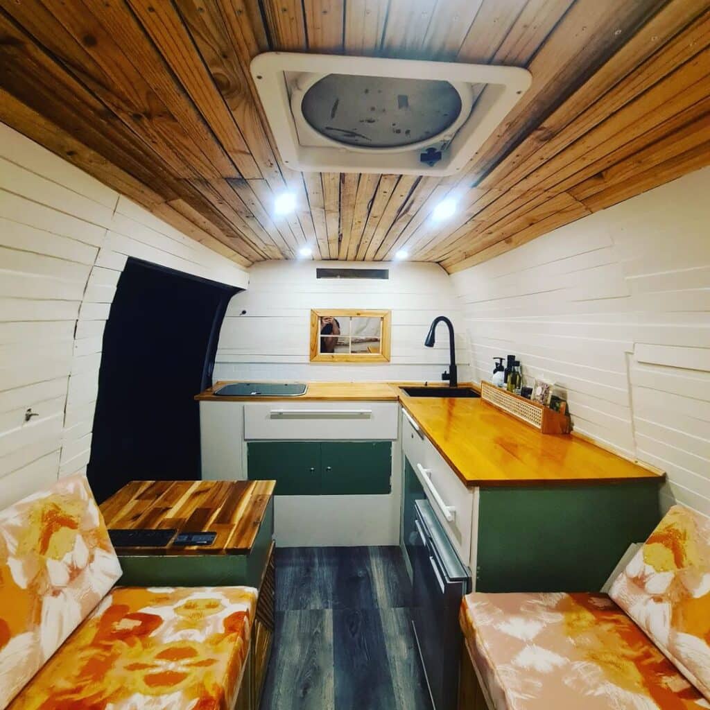 @ausvan_adventure Cozy campervan interior with an L-shaped kitchen