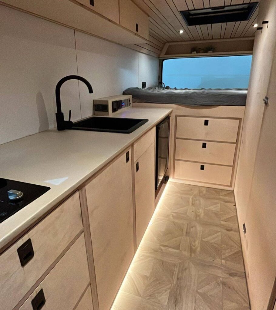 @our_orbit_vanlife Camper van kitchen with modern interior