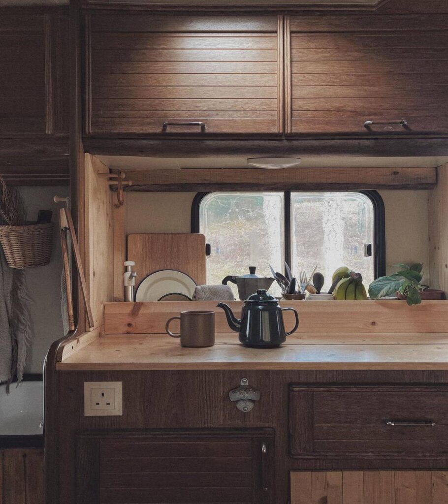 @thiscabinvan Van kitchen with wood storage cabinets