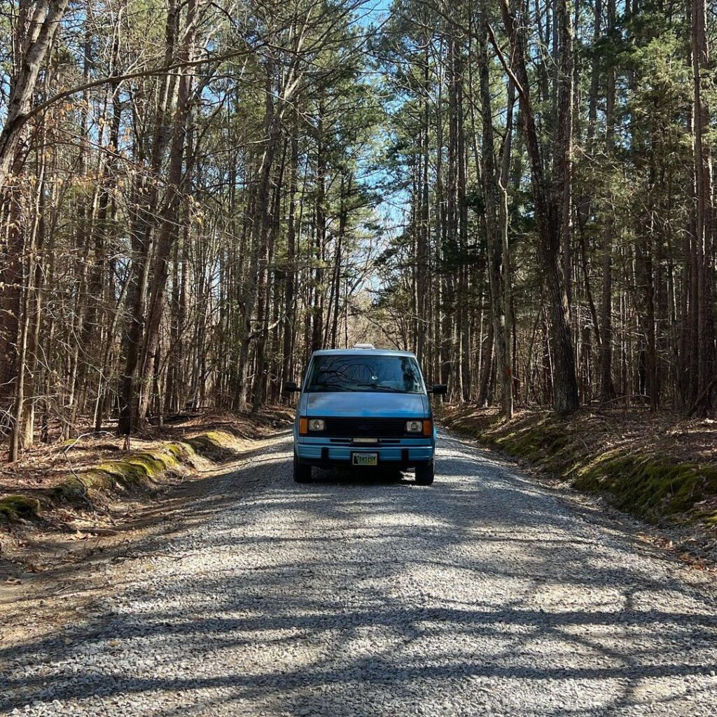 @﻿the_ethnic_explorer Blue camper parked at the trailhead