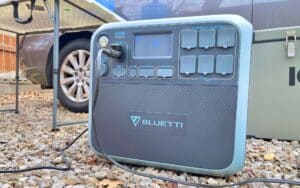 Bluetti AC200P review power station sitting on a gravel pad in front of a camper van
