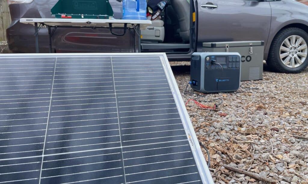 Solar panels set up to charge the Bluetti AC200P at a van life camp site