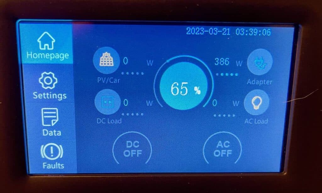 The touchscreen display on the Bluetti AC200P showing input and output Wattages and battery SOC