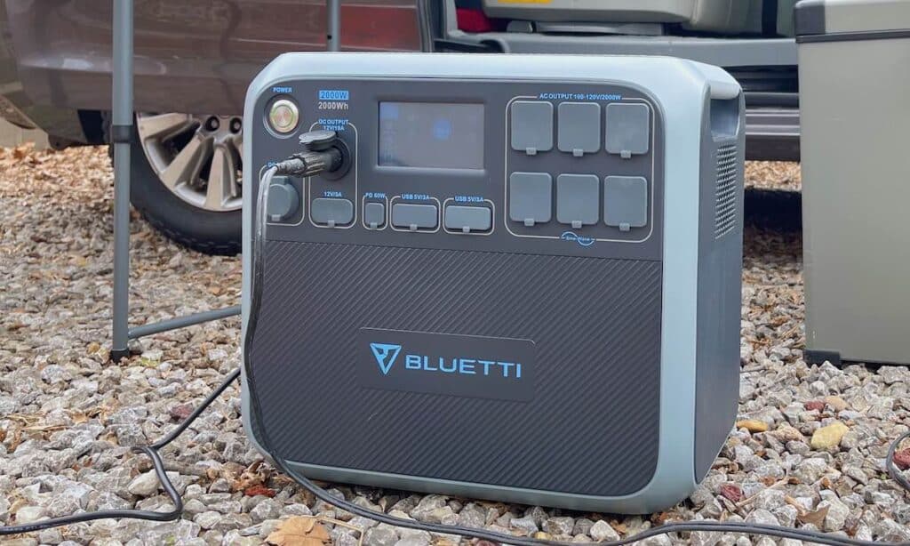 Bluetti AC200P solar generator sitting at a campsite