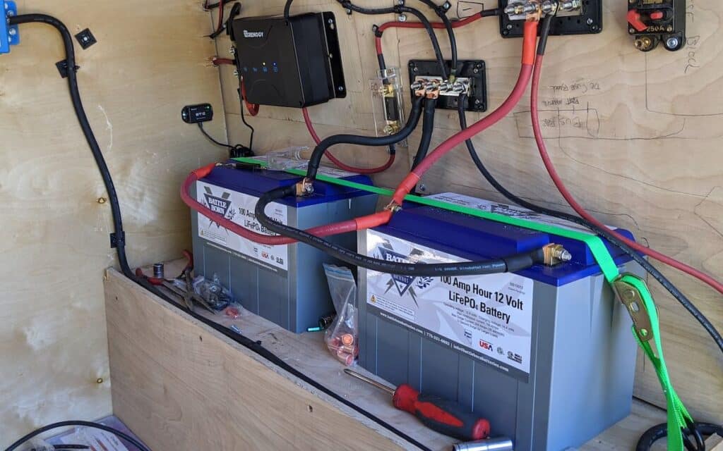 a campervan electrical system with batteries all set up to power a van fridge