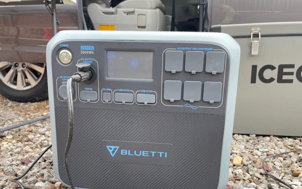 bluetti AC200P power station with an Iceco vanlife fridge in the background