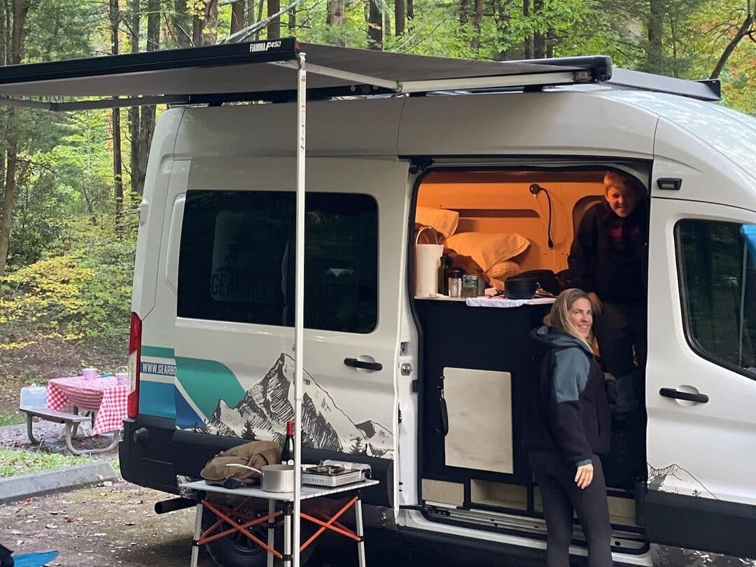 @gearbox_adventure_rentals Couple camping together in the forest with a rented campervan from Gearbox Adventure