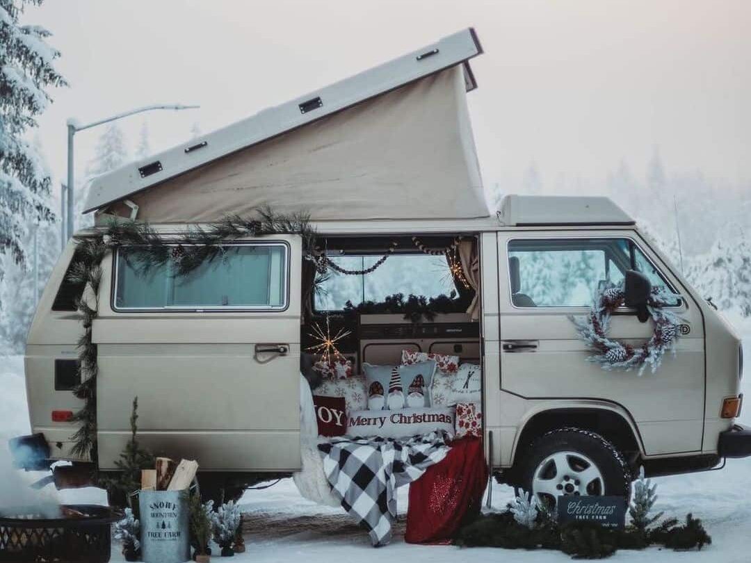 @last_frontier_westys VW T3 camper adorned with Christmas ornaments parked in snow