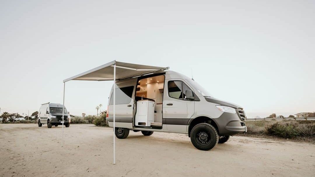 @van_craft Sprinter van parked in the desert with awning extended