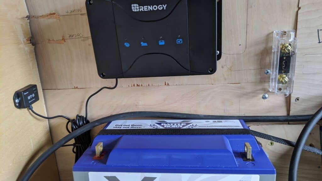 a battery and solar charge controller mounted in a campervan with an ANL fuse